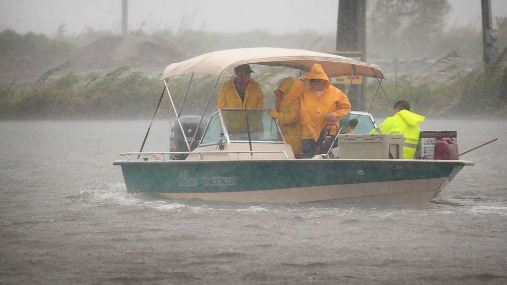 PHOTO: Boaters head out in a driving rain to survey damage to their fish camps in the wake of Hurricane Barry, July 14, 2019, in Myrtle Grove, La. 