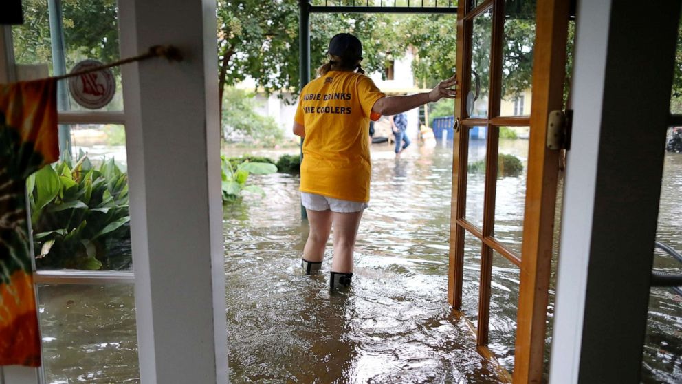 PHOTO: Robyn Iacona-Hilbert stands outside her flooded business after Hurricane Barry came ashore in Mandeville, La., on Saturday, July 13, 2019.
