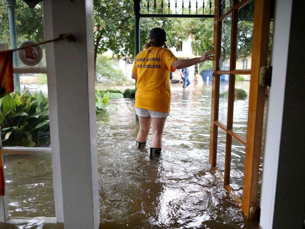 PHOTO: Robyn Iacona-Hilbert stands outside her flooded business after Hurricane Barry came ashore in Mandeville, La., on Saturday, July 13, 2019.
