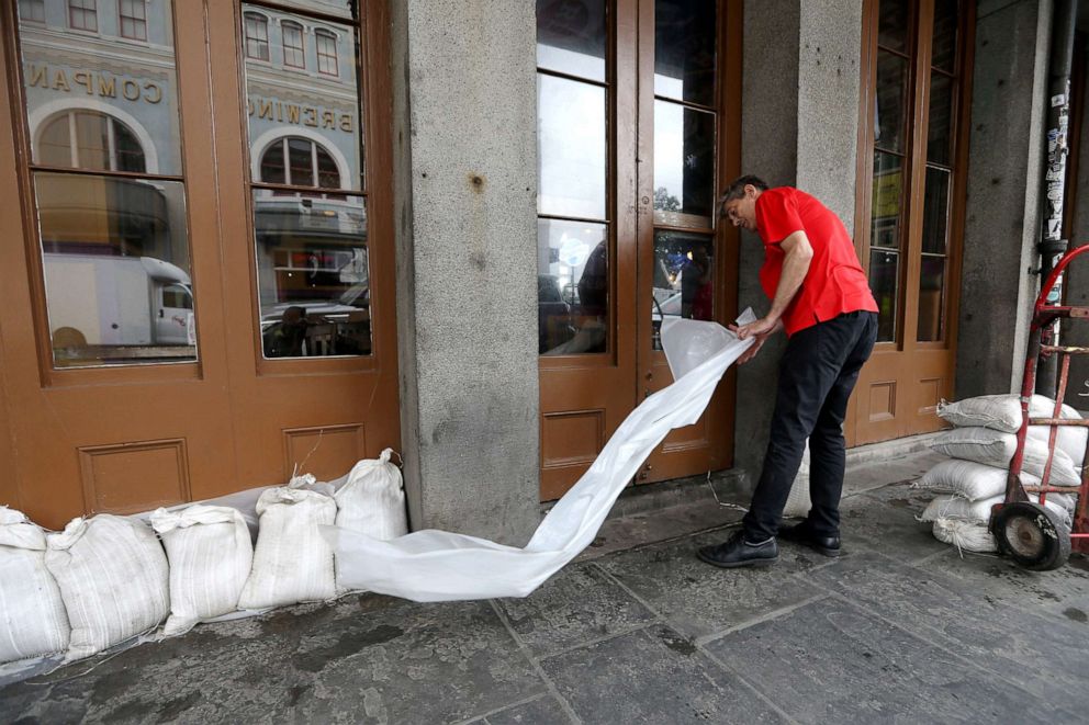 PHOTO: An employee places sandbags in front of a business in the French Quarter as Tropical Storm Barry approaches land in New Orleans, Louisiana, July 12, 2019.