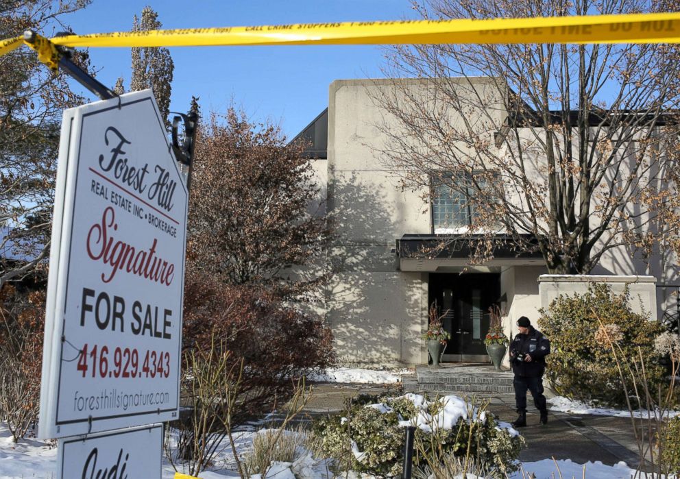 PHOTO: A police forensics photographer works outside the home of founder of pharmaceutical firm Apotex Inc., Barry Sherman and his wife Honey Toronto, Canada Dec. 16, 2017. 