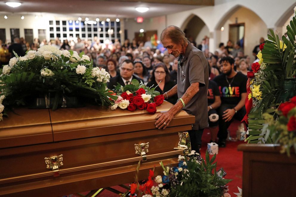 PHOTO: Antonio Basco, whose wife Margie Reckard was murdered during a shooting at a Walmart store, stands next to her coffin at a visitation service to which he had invited the public in El Paso, Texas, on Friday, Aug. 16, 2019.