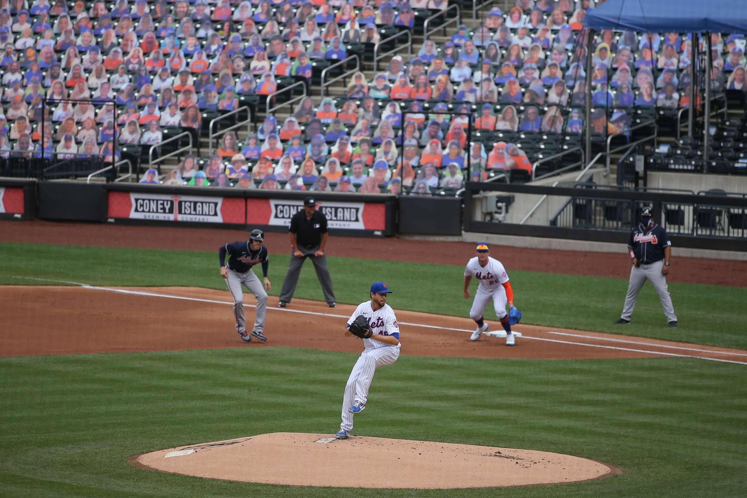 PHOTO: New York Mets starting pitcher Jacob deGrom pitches as Atlanta Braves first baseman Freddie Freeman takes a lead against Mets first baseman Pete Alonso during the first inning of an opening day game at Citi Field, July 24, 2020, in New York.