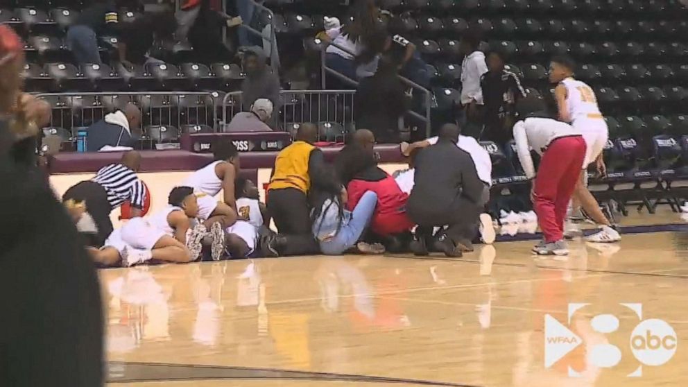 PHOTO: In this still from a video, people react after a shooting broke out at a high school basketball game in Dallas over the weekend.