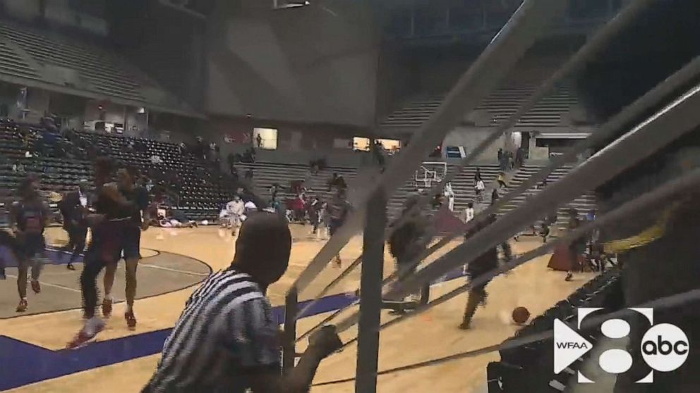 PHOTO: In this still from a video, people run after a shooting broke out at a high school basketball game in Dallas over the weekend.