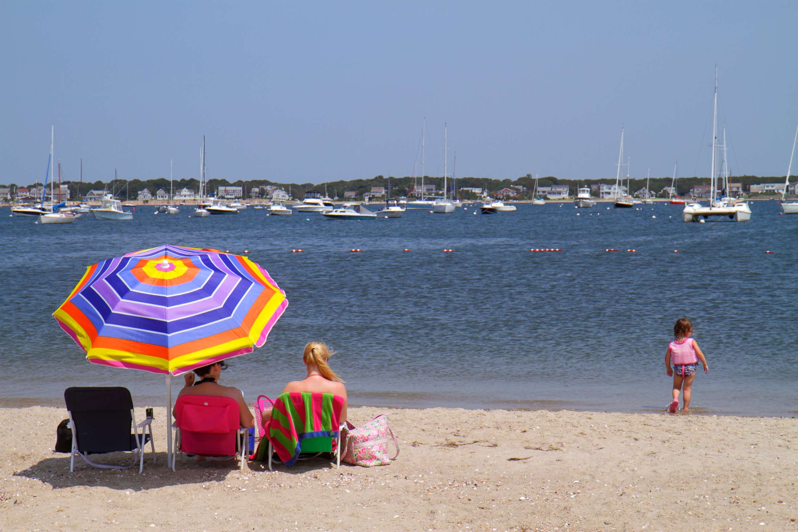 PHOTO: Sunbathers sat under an umbrella at Kalmus Beach Park in Hyannis, Mass., Oct. 27, 2015.