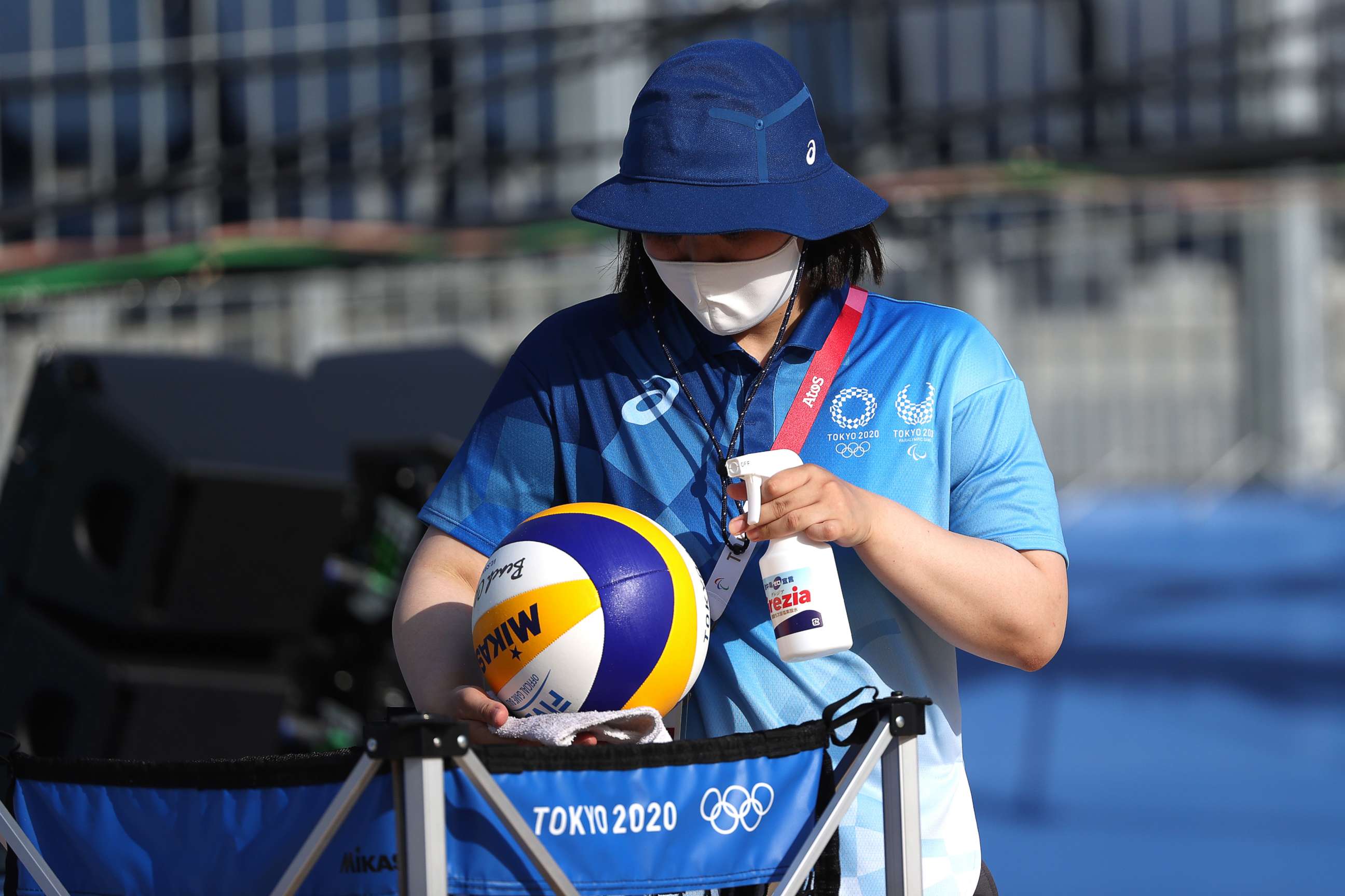 PHOTO: A worker sanitizes beach volleyballs during training at Shiokaze Park ahead of the Tokyo 2020 Olympic Games on July 20, 2021, in Tokyo.