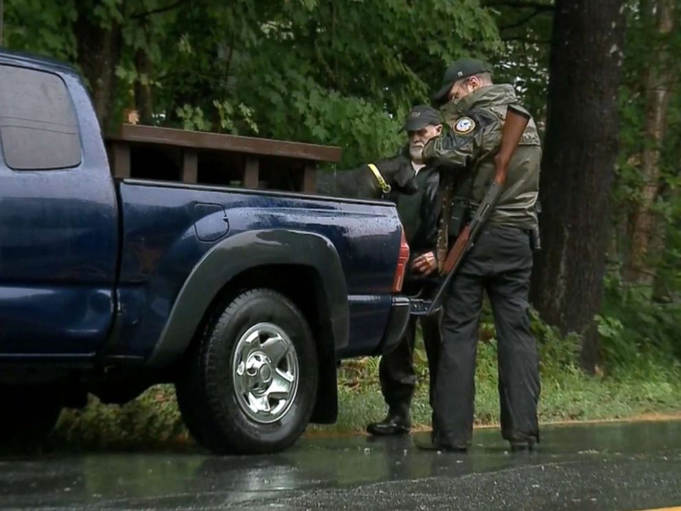 PHOTO: A team from the New Hampshire Fish and Game Department searches the area after a 71-year-old woman was attacked by a bear that entered her home in Groton, N.H., early in the morning on July 17, 2018.