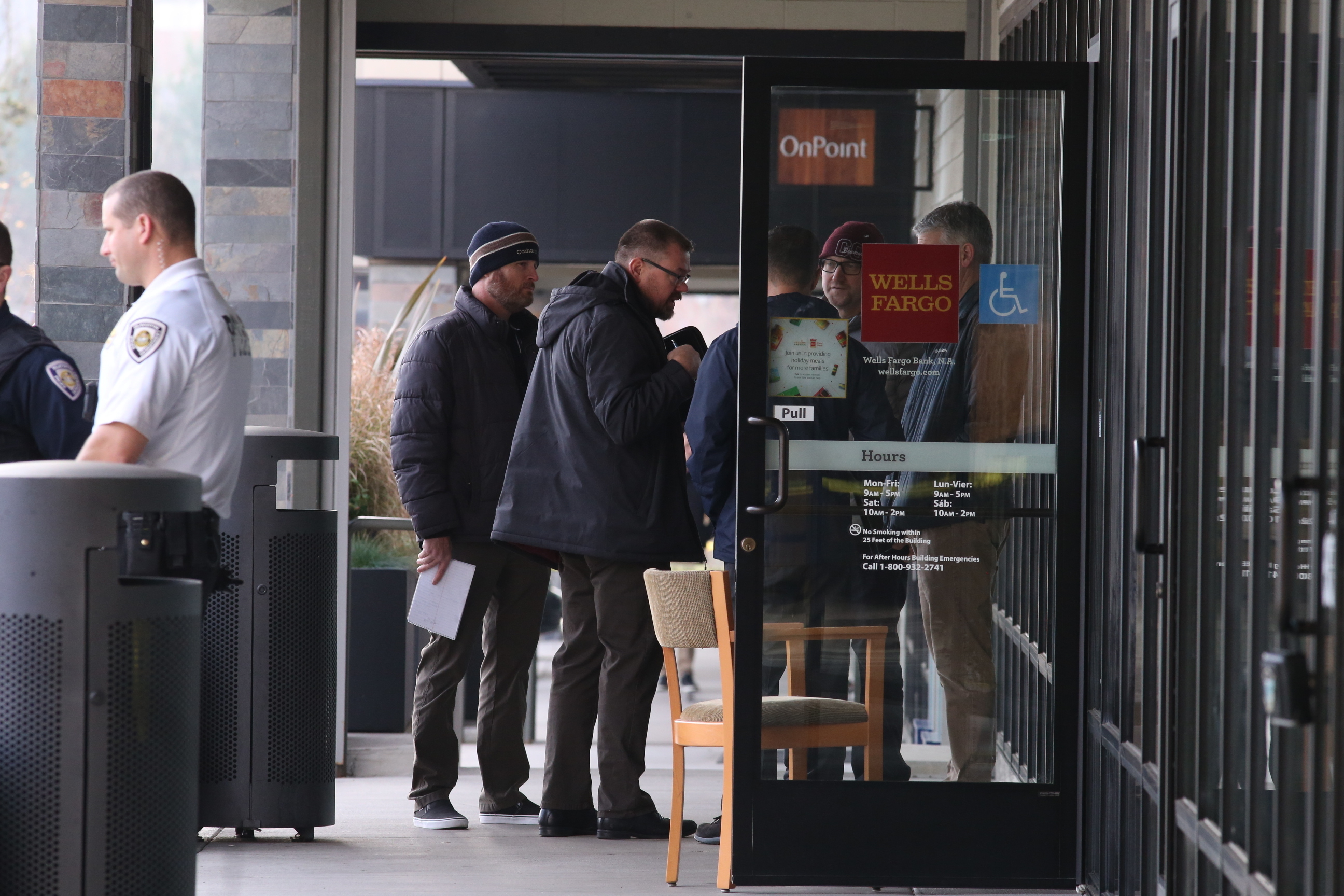 PHOTO: Investigators enter a bank after an attacker stabbed multiple people at a suburban Portland shopping center, Dec. 18, 2019.