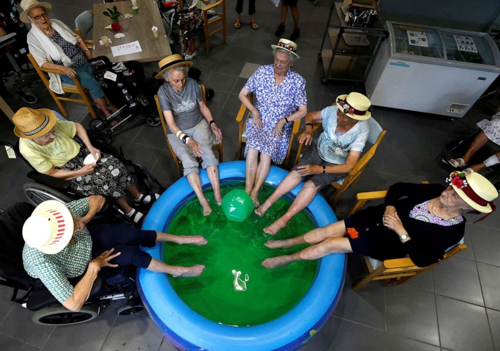 PHOTO: Residents at the Ter Biest house for the elderly dip their feet in a pool as a heatwave hits Europe, in Grimbergen, Belgium on July 19, 2022.