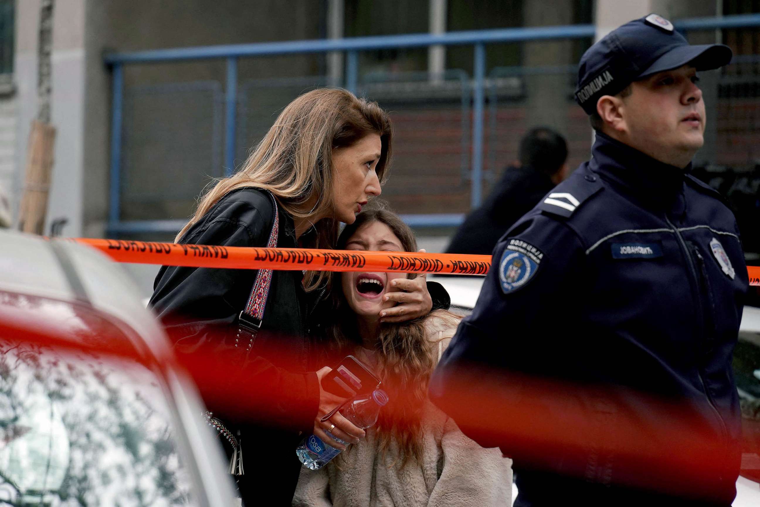 PHOTO: A parent escorts her child following a shooting at a school in the capital Belgrade, May 3, 2023.