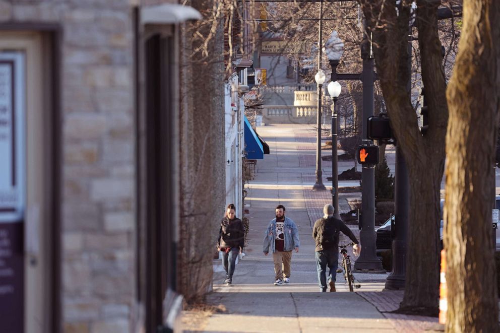 PHOTO: People walk along State Street in the business district on Feb. 26, 2023, in Belvidere, Illinois.