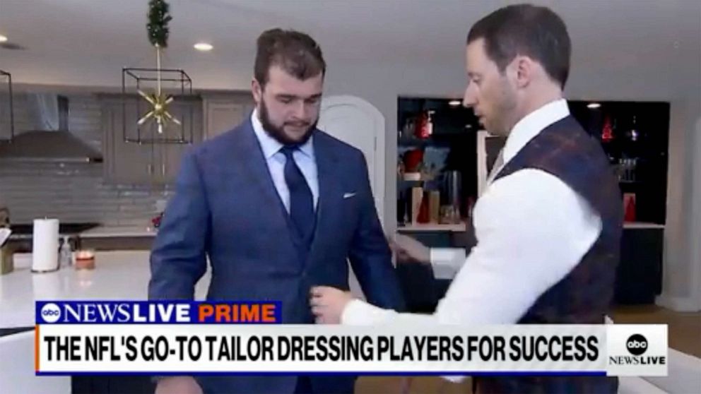 Photo: New York Giants linebacker Ben Bredesen tries on a suit designed by Tom Marchatelli.