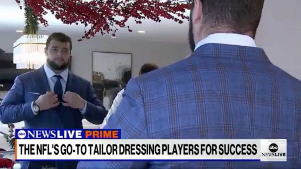 PHOTO: New York Giants lineman Ben Bredeson tries on a Tom Marchitteri suit.