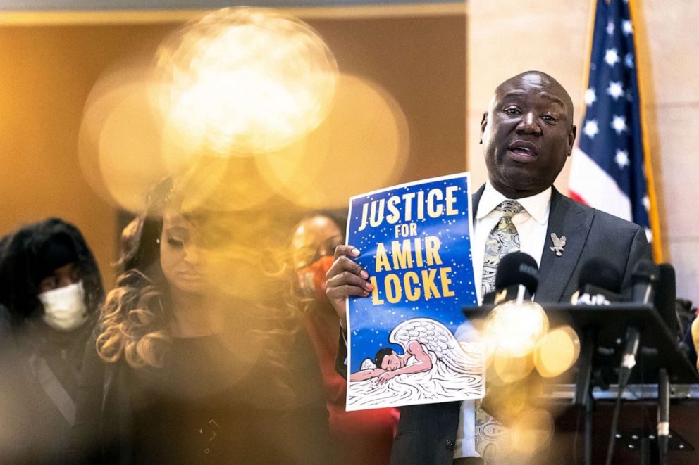 PHOTO: Civil rights attorneys Ben Crump holds a sign reading "Justice for Amir Locke" during a news conference in St. Paul , Minnesota on February 10, 2022.