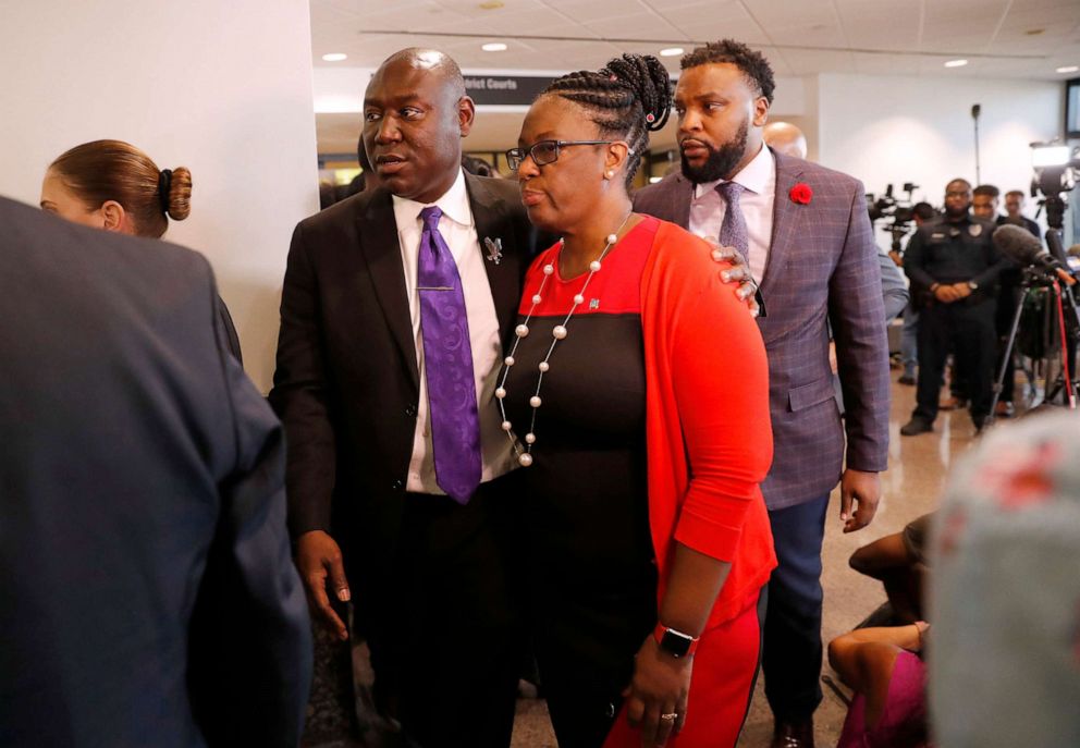 PHOTO: In this Oct. 2, 2019, file photo, attorneys Ben Crump, left, and Lee Merritt, rear, walk with Allison Jean, mother of Botham Jean, after the sentencing phase of Dallas police officer Amber Guyger murder trial in Dallas.