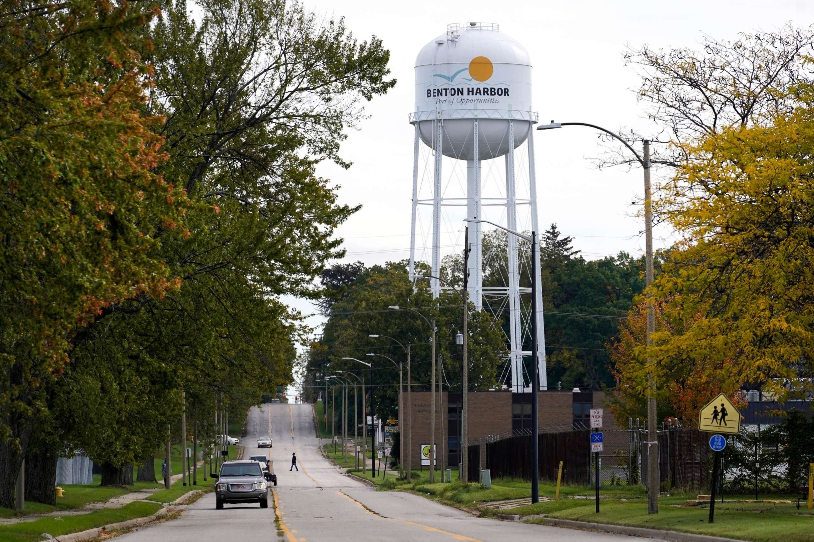 PHOTO: A lone resident of Benton Harbor, Mich., walks across Britain Street Friday, Oct. 22, 2021, near the city's water tower in Benton Harbor.