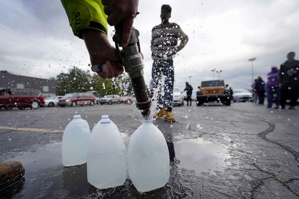 PHOTO: The Berrien County Road Department fills up jugs with non-potable water in the Benton Harbor High School parking lot, Oct. 21, 2021, in Benton Harbor, Mich.