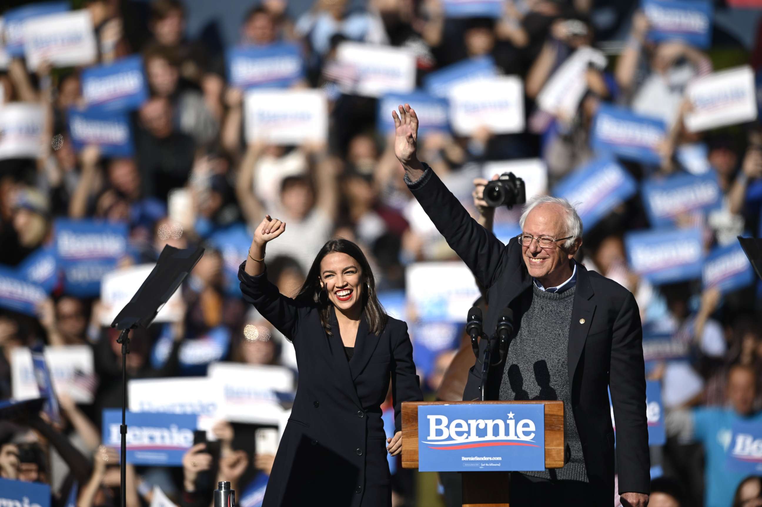 PHOTO: 2020 Democratic presidential hopeful US Senator Bernie Sanders (D-VT) and representative Alexandria Ocasio-Cortez (D-NY) wave to a crowd of supporters during a campaign rally on October 19, 2019  in New York City.