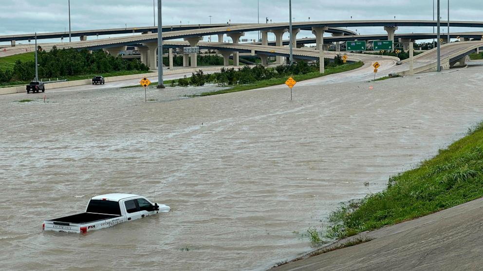 PHOTO: A vehicle is stranded in high waters on a flooded highway in Houston, July 8, 2024, after Beryl came ashore in Texas as a hurricane and dumped heavy rains along the coast.