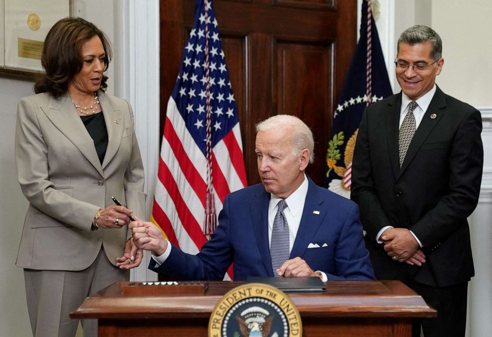 PHOTO: President Joe Biden hands the pen to Vice President Kamala Harris after signing an executive order at the White House in Washington, July 8, 2022.