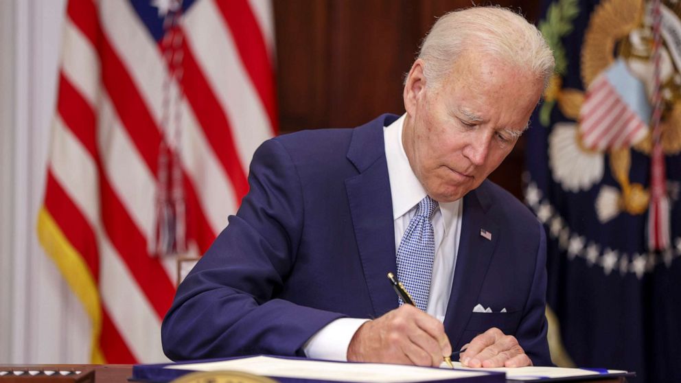 PHOTO: President Joe Biden signs the Bipartisan Safer Communities Act into law in the Roosevelt Room of the White House, June 25, 2022. The legislation is the first new gun regulations passed by Congress in more than 30 years.