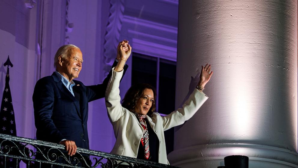 PHOTO: President Joe Biden and Vice President Kamala Harris join hands in the air after watching the fireworks on the National Mall from the White House balcony, July 4, 2024, in Washington.