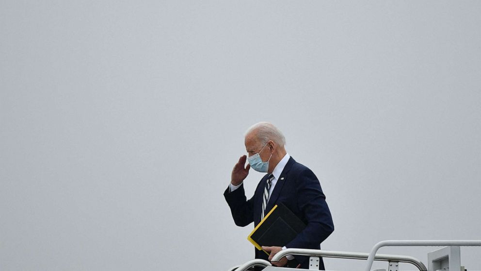 PHOTO: US President Joe Biden salutes before he boards Air Force One departing from New Castle Airport in New Castle, Delaware on March 1, 2021. - Biden is returning to Washington after spending the weekend at his Wilmington home. 