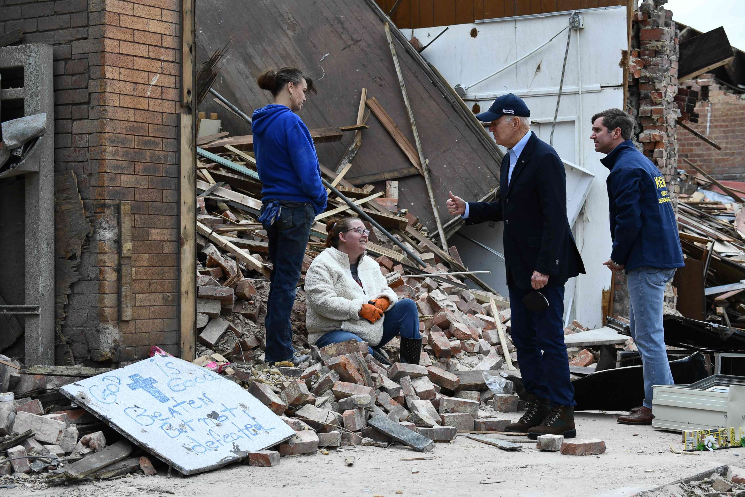 PHOTO: President Joe Biden speaks with a resident as he tours storm damage in Mayfield, Ky., on Dec. 15, 2021.