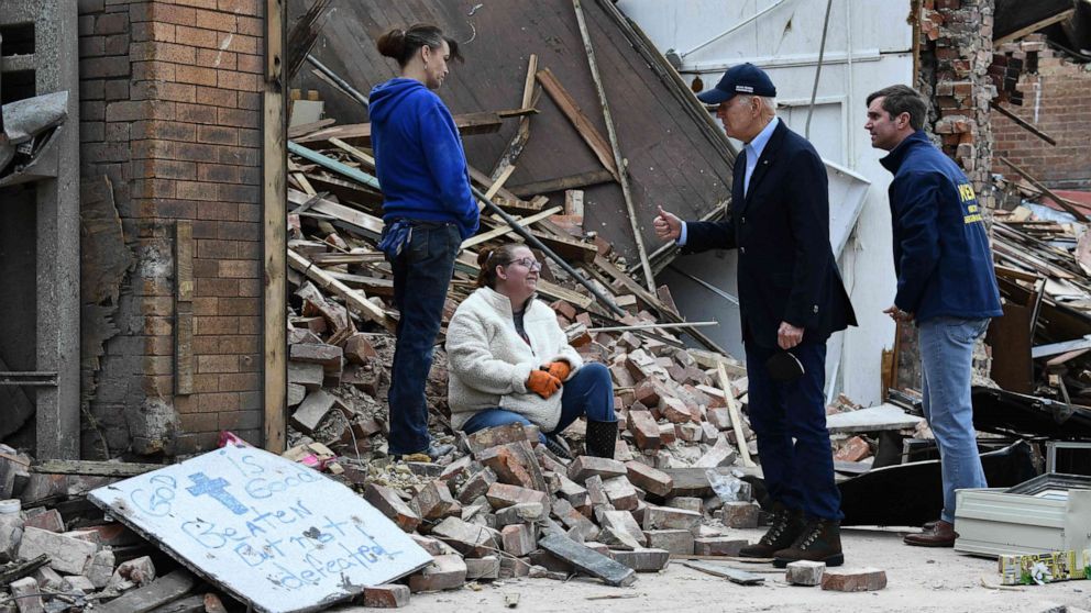 PHOTO: President Joe Biden speaks with a resident as he tours storm damage in Mayfield, Ky., on Dec. 15, 2021.