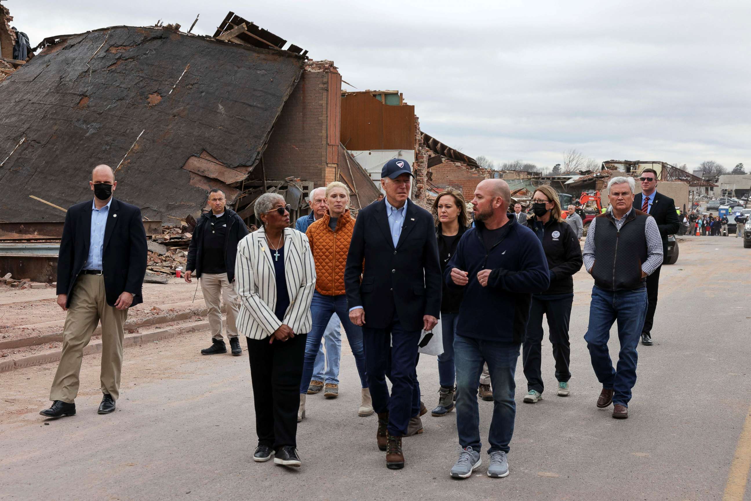 PHOTO: President Joe Biden tours a neighborhood with Kentucky's first lady Britainy Beshear, Anne Henning Byfield, Presiding Bishop of the AME Council of Bishops and Jesse Perry, Graves County Judge Executive, in Mayfield, Ky., Dec. 15, 2021.