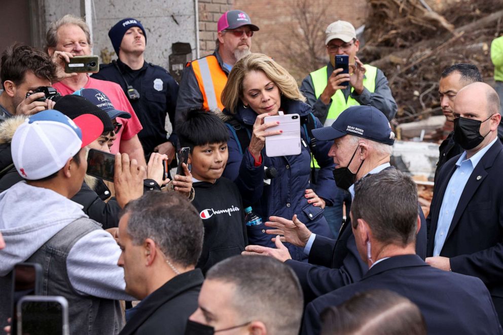 PHOTO: People record as President Joe Biden speaks during his tour of a neighborhood in Mayfield, Ky., Dec. 15, 2021.