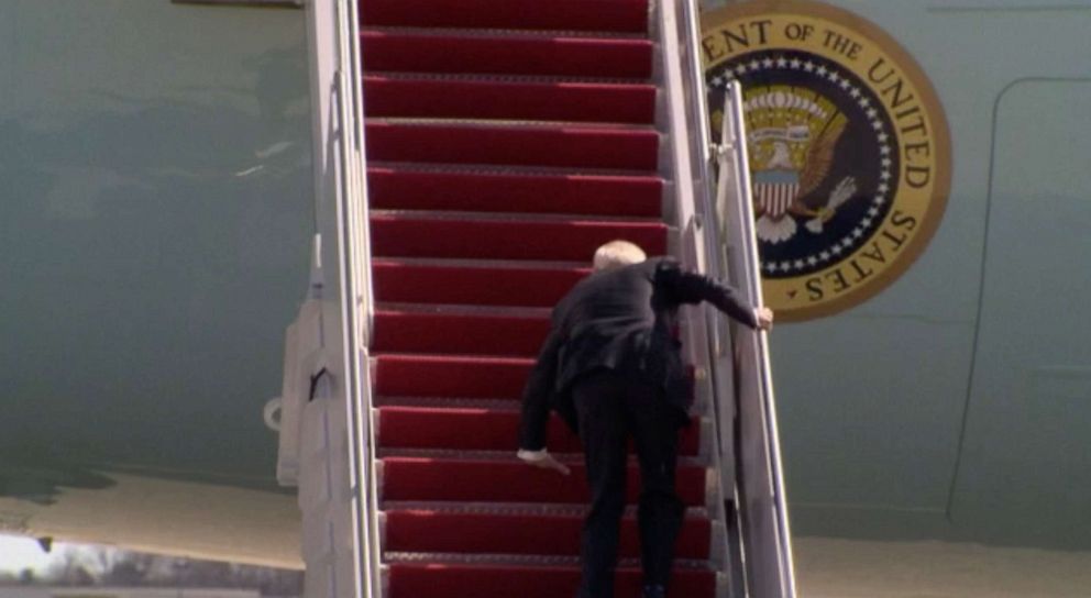 PHOTO: President Joe Biden stumbles while walking up the steps of Air Force One at Joint Base Andrews, Md., March 19, 2021, for a trip to Georgia.