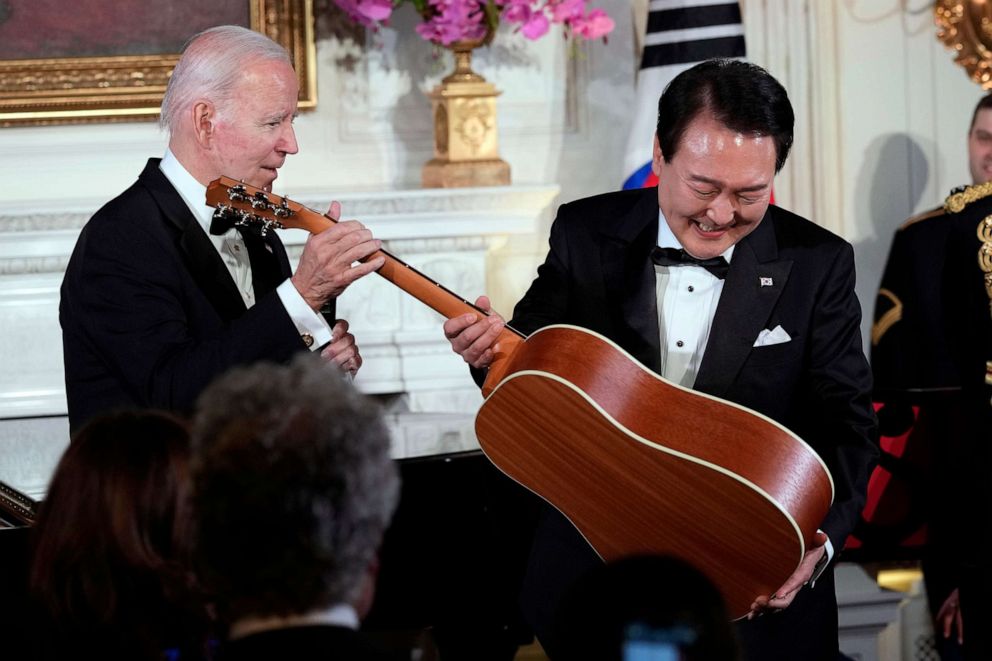 PHOTO: President Joe Biden surprises South Korea's President Yoon Suk Yeol with a guitar signed by Don McLean in the State Dining Room of the White House, April 26, 2023, following the state dinner.