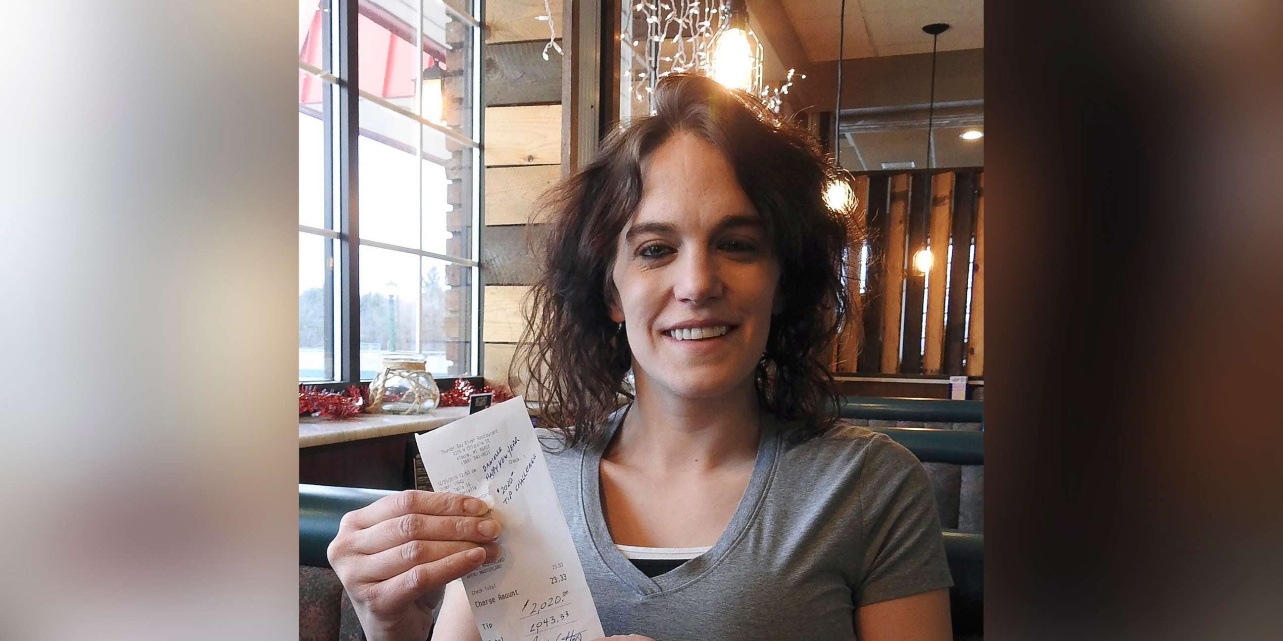 PHOTO: Server Danielle Franzoni holds a receipt from a customer with a $2,020 tip included at Thunder Bay River Restaurant in Alpena, Mich., Dec. 30, 2019. The credit card receipt said "Happy New Year. 2020 Tip Challenge."