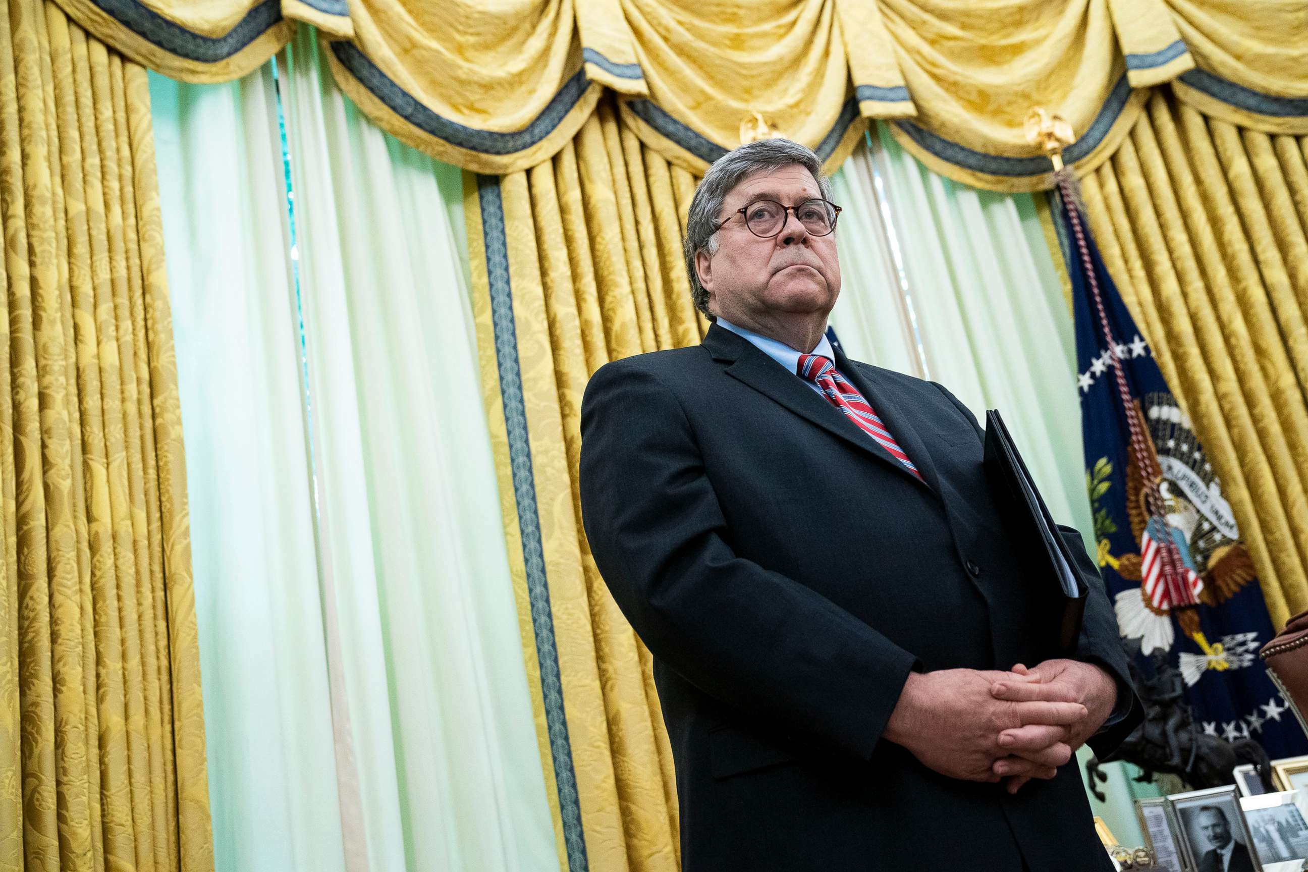 PHOTO: Attorney General William Barr listens as President Donald Trump speaks in the Oval Office before signing an executive order related to regulating social media on May 28, 2020, in Washington, DC.
