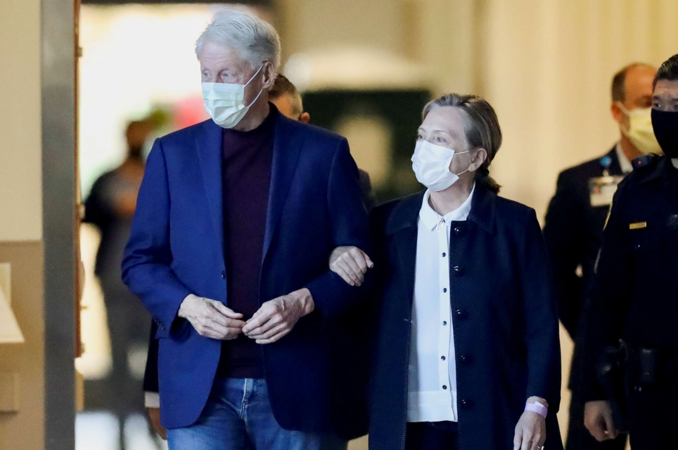 PHOTO: Former U.S. President Bill Clinton, accompanied by his wife, former Secretary of State Hillary Clinton, walks out of University of California Irvine Medical Center, in Orange, California, U.S. October 17, 2021. 