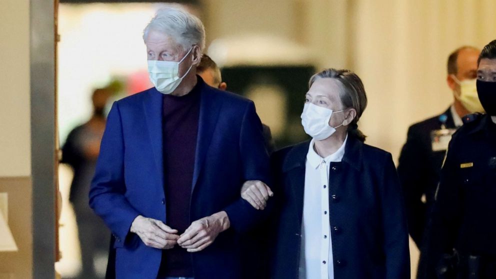 PHOTO: Former U.S. President Bill Clinton, accompanied by his wife, former Secretary of State Hillary Clinton, walks out of University of California Irvine Medical Center, in Orange, California, U.S. October 17, 2021. 