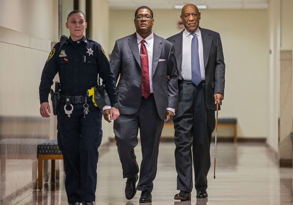 PHOTO: Bill Cosby, right, holds onto Andrew Wyatt as they are escorted by an officer for a short break during the second day of jury selection in his sexual assault retrial, at the Montgomery County Courthouse in Norristown, Pa., April 3, 2018.