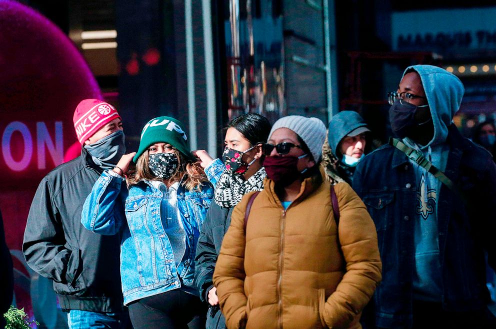 PHOTO: People wear protective face masks as they walk in Times Square in New York on Dec. 10, 2020. 