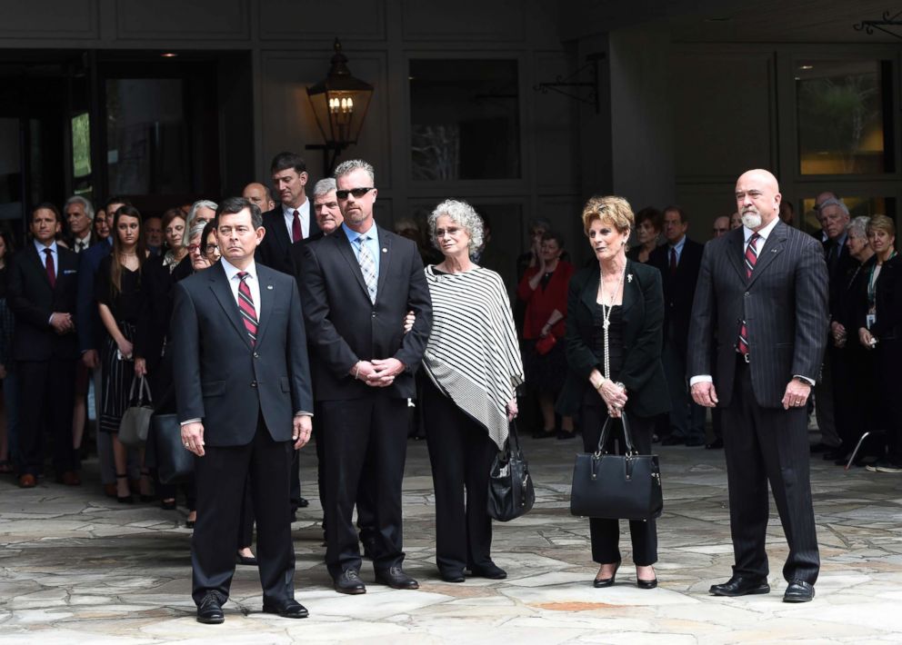 PHOTO: Family members look on as the body of Rev. Billy Graham is carried to the hearse to leave the Billy Graham Training Center at the Cove, Feb. 24, 2018 in Asheville, N.C.