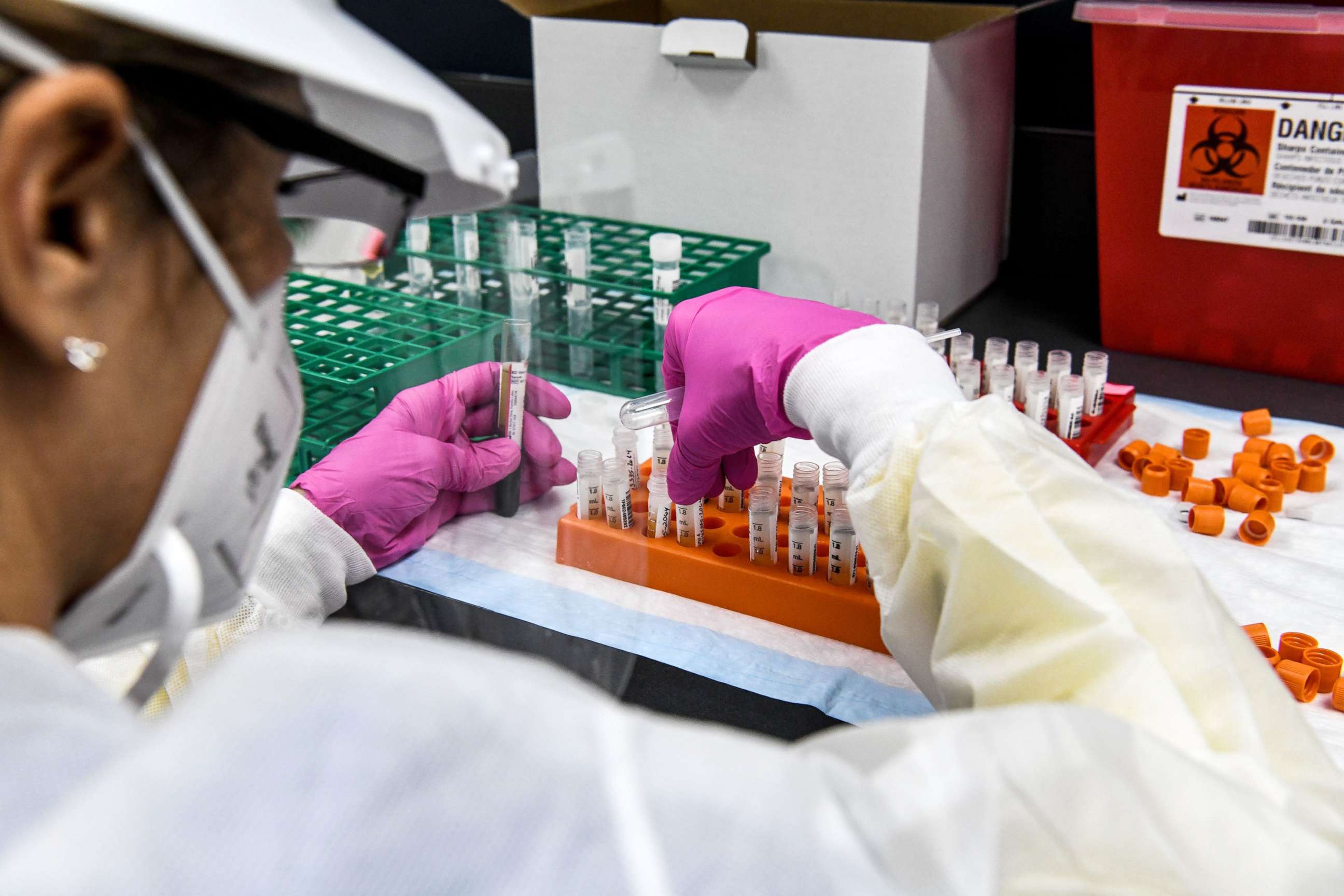 PHOTO: A lab technician sorts blood samples inside a lab for a COVID-19 vaccine study at the Research Centers of America  in Hollywood, Fla., Aug. 13, 2020. 