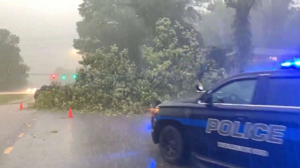 PHOTO: A police vehicle is seen next to a felled tree along a road during floods in Birmingham, Alabama, U.S. May 4, 2021, in this still image obtained from a social media video. Courtesy of @davis_ebbert/Social Media via REUTERS. 