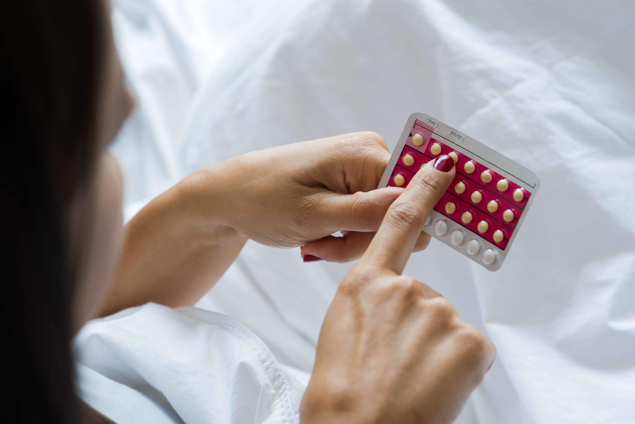 PHOTO: Stock image of woman holding birth control pills. 