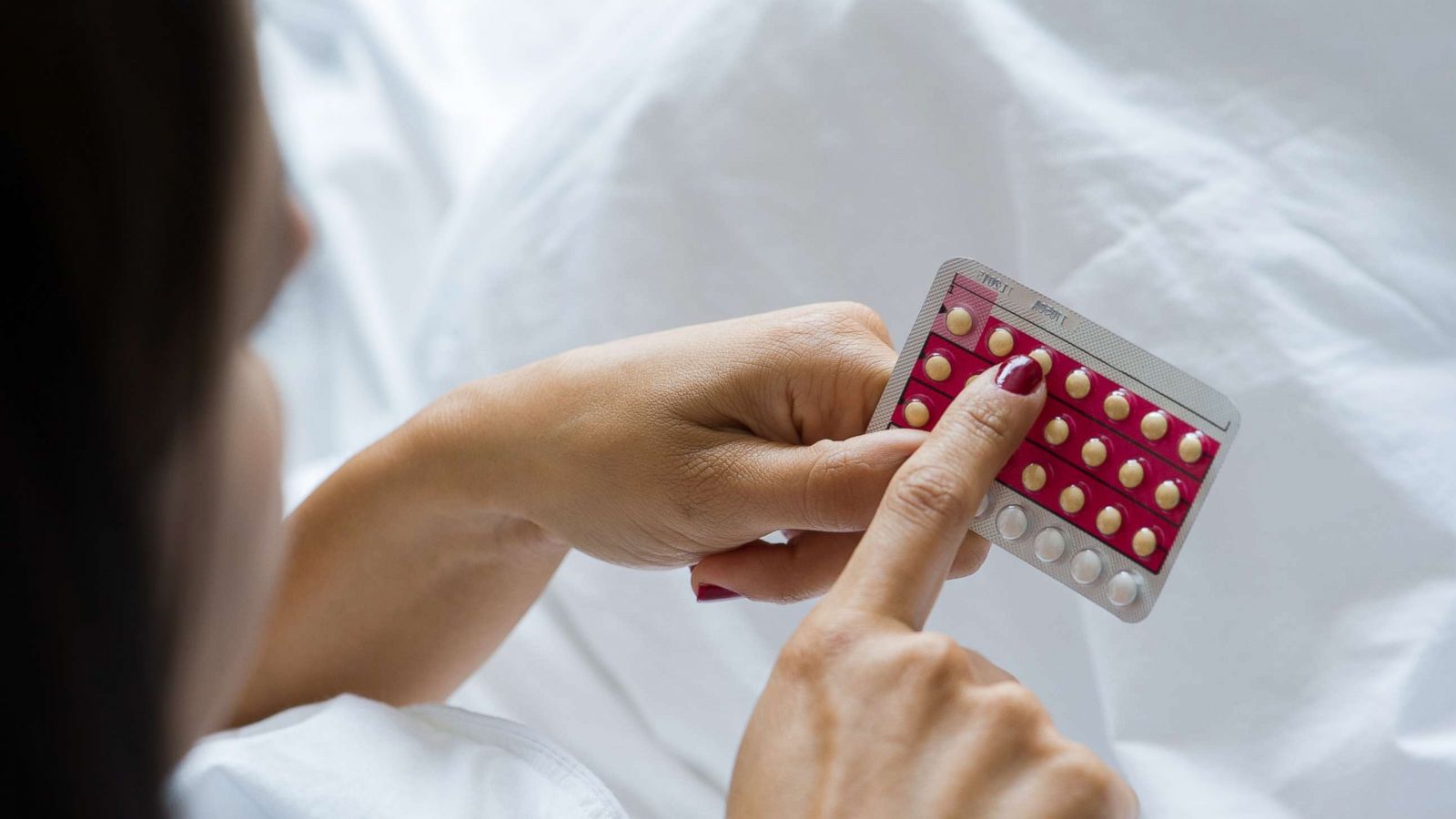 PHOTO: Stock image of woman holding birth control pills.