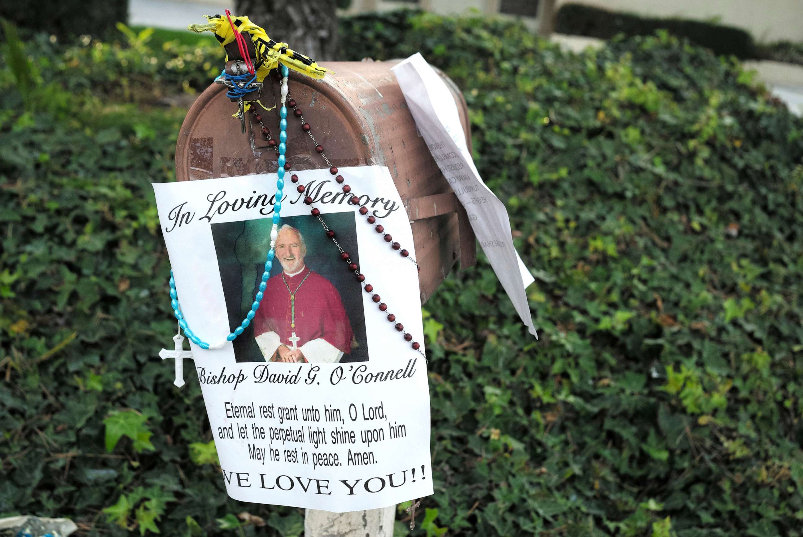 PHOTO: A picture with a prayer hangs on the mailbox as a makeshift memorial grows for Bishop David O'Connell, Feb. 21, 2023, in front of his home in Hacienda Heights, Calif.