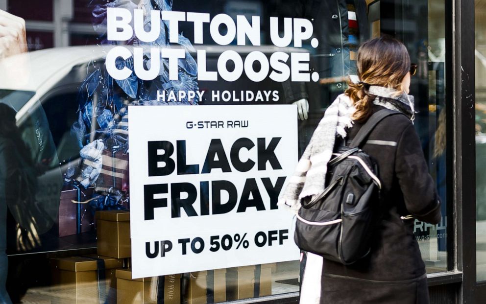 PHOTO: A person walks past a sign for a Black Friday related sale in New York, Nov. 25, 2019. 