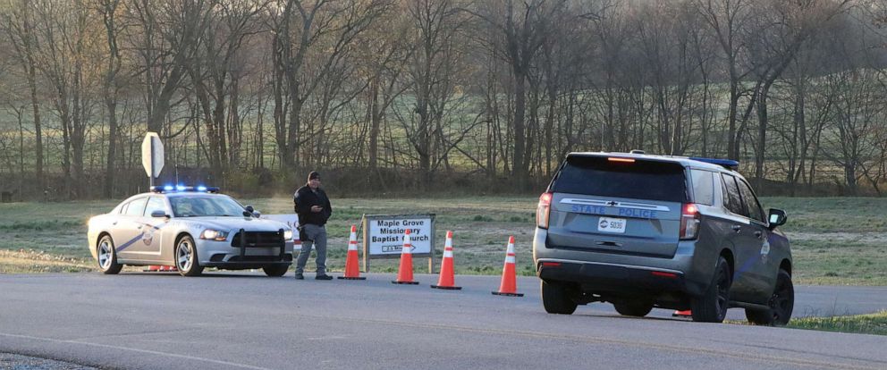 PHOTO: A security official stands near police cars at a site where two U.S. Army Black Hawk helicopters crashed in Trigg County, Kentucky, March 30, 2023.