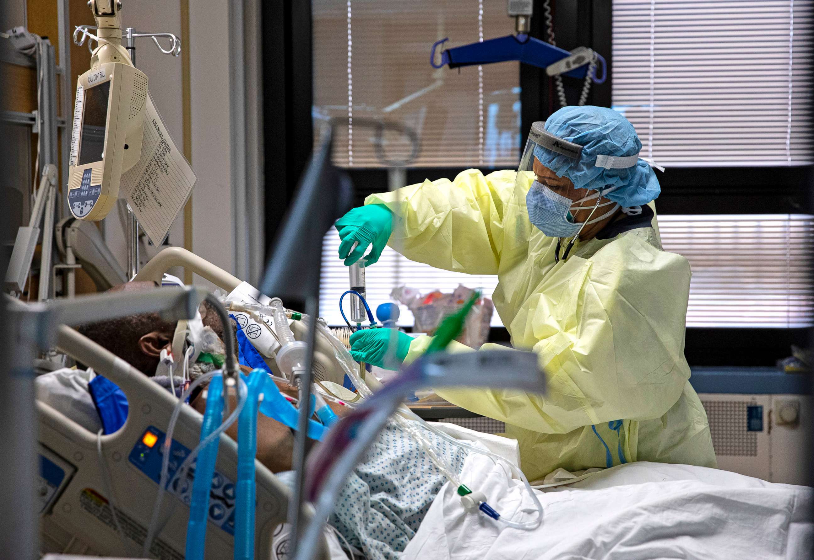 PHOTO: A nurse puts medication or water into the feeding tube of a COVID-19 patient at the Medical Intensive Care Unit floor, MICU, at the Veterans Affairs Medical Center April 24, 2020 in the Manhattan borough of New York City. 
