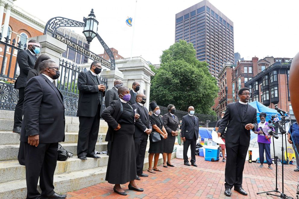 PHOTO: The Rev. Rahsaan Hall takes questions as a group of twelve ministers, from African Methodist Episcopal churches across the state, gather in front of the State House in Boston to urge the House to pass police reform legislation, July 20, 2020.